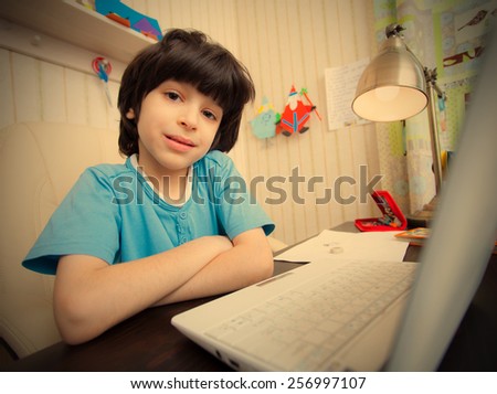 schoolboy doing homework on a laptop. instagram image retro style