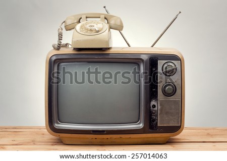 old phone and old tv vintage style on gray background . Royalty-Free Stock Photo #257014063