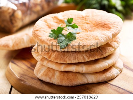 pita bread on wooden board Royalty-Free Stock Photo #257018629
