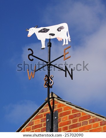 Dairy Cow Weather-vain set against a Blue Sky