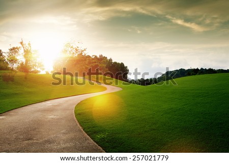 panoramic view of nice green hill and path during sunset Royalty-Free Stock Photo #257021779