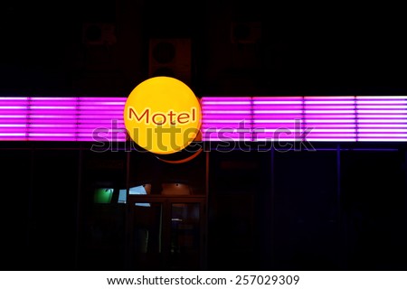 Motel sign on building at night