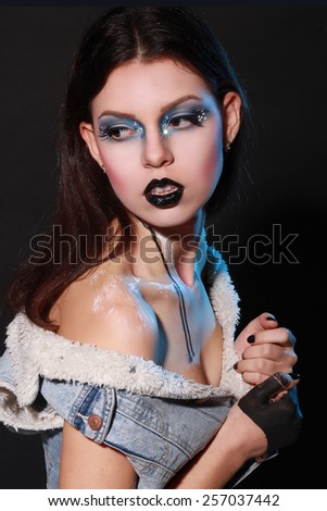 Beatiful girl with creative black make-up