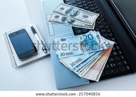 Workplace with money and electronic devices