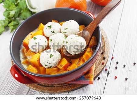 Baked pumpkin and chicken meatballs with herbs in a saucepan
