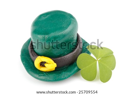 Three leaf clover and Green Leprechaun Hat on a white background. St. Patrick's Day symbol.