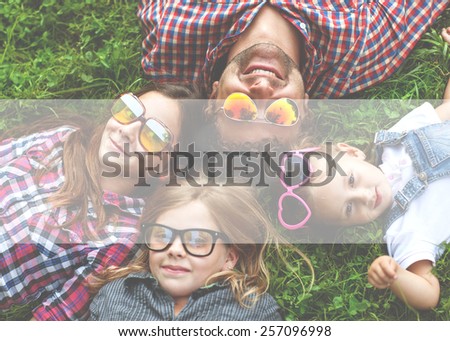Dad and his 3 daughters lie on the grass in sunglasses happy. hipster Style 