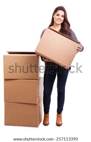 Portrait of a beautiful young brunette packing carrying some boxes to move into her new home