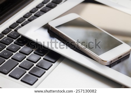 set of modern computer devices  - laptop, tablet and phone close up Royalty-Free Stock Photo #257130082