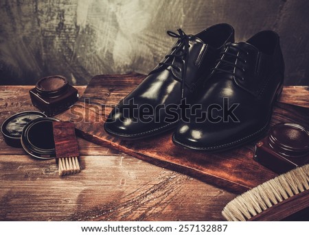 Shoe care accessories on a wooden table  Royalty-Free Stock Photo #257132887