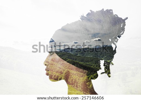 Double exposure of girl with braids and landscape