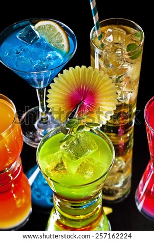 Variety of colorful cocktails over starry black background