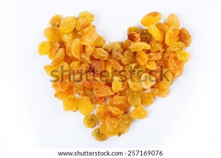 Heart from sultanas on white background