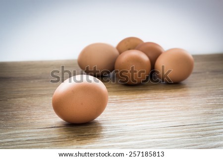 eggs on a wooden table selective focus, focus at the front egg