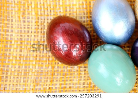 Colorful easter eggs on bamboo weave sheet background. 