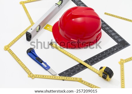 Photo of the Helmet and tools for construction drawings and buildings