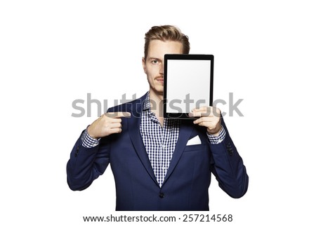 Portrait of a cheerful young man is showing something on digital tablet.