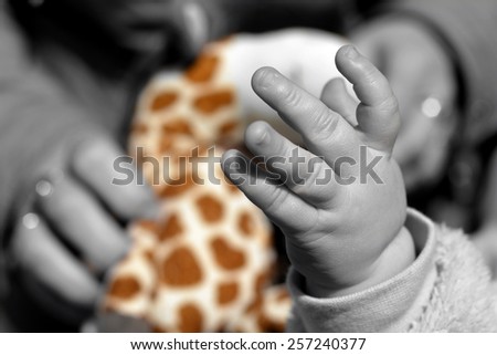 Child's hand playing on toy