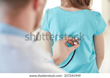 healthcare, medical exam, people, children and medicine concept - close up of girl and doctor with stethoscope listening to heartbeat Royalty-Free Stock Photo #257241949