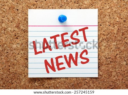 The phrase Latest News on a lined index card pinned to a cork bulletin board Royalty-Free Stock Photo #257245159