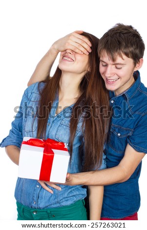 Valentine Gift. Happy Young beautiful Couple  isolated on a White background. Happy Man giving a gift to his Girlfriend. Holiday