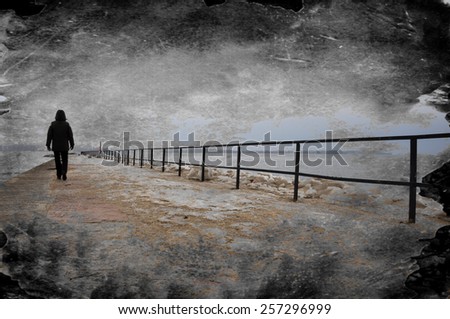 Creative grungy textured image of lonely person walking on pier. Royalty-Free Stock Photo #257296999