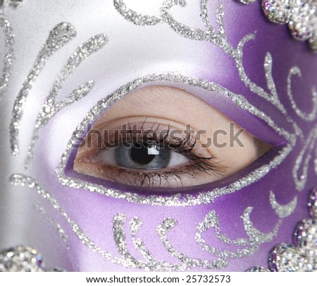 A girl in a halloween or mardi gras mask on a white background