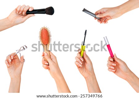 Hands with professional cosmetics for makeup: brush, eye primer, mascara, lip booster, comb Royalty-Free Stock Photo #257349766