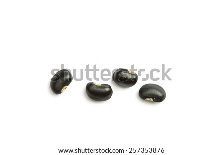 Close up black beans isolated on white background Royalty-Free Stock Photo #257353876