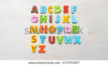 Cute and colorful wooden alphabet letter set. Concept of back to school. Shot with natural light. Slightly defocused and close-up shot. Copy space.