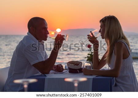 Couple drinking wine at sunset 