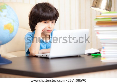 boy looking at a computer monitor, distance learning