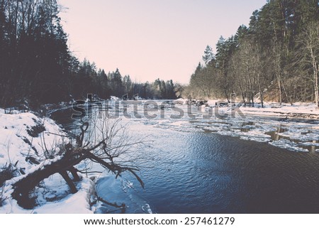 frozen river in winter with sandstone cliffs and ice blocks. Gauja National Park. Latvia. - retro vintage effect