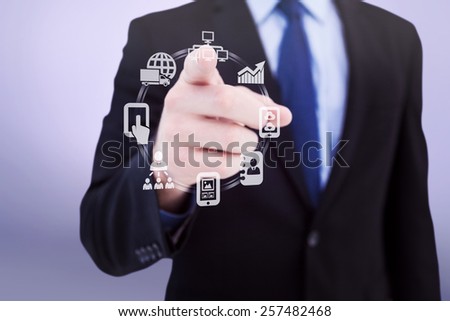Businessman pointing his finger at camera against grey vignette