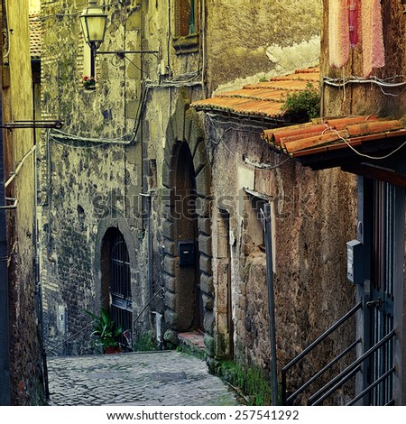Narrow Alley with Old Buildings in Italian City of Cave, Vintage Style Toned Picture