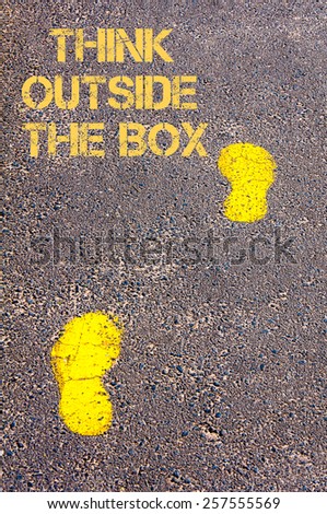 Yellow footsteps on sidewalk towards Think Outside The Box message.Conceptual image