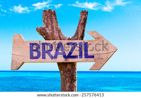 Brazil wooden sign with a beach on background