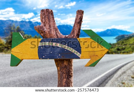 Brazil Flag wooden sign with a road background