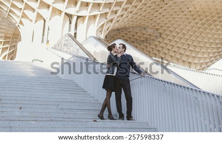 Young couple in love at the Metropol Parasol Seville, Spain.