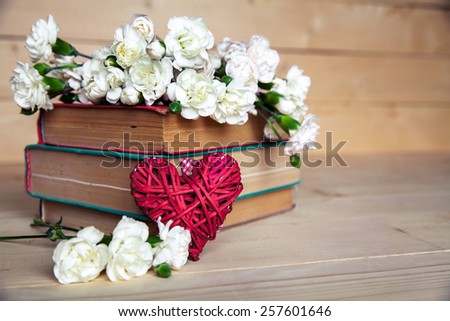 flowers. gentle carnation in the old book on a wooden background.