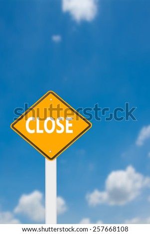 yellow cautionary road sign close against a beautiful sky background