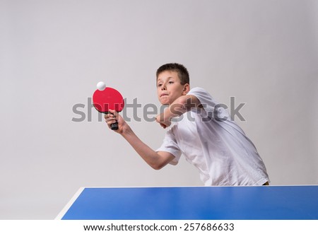 little boy playing table tennis