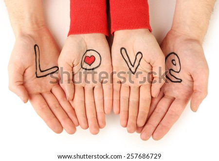 Hands of couple with inscription Love isolated on white