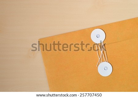 manila envelope isolated on wood background. Above view.