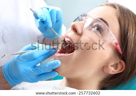 Overview of dental caries prevention.Woman at the dentist's chair during a dental procedure Royalty-Free Stock Photo #257732602
