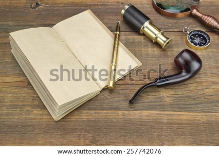 Open Vintage Notebook With Blank Pages, Gold Fountain Pen, Retro Magnifier, Compass and Spyglass On Grunge Wooden Table Background