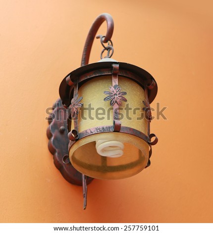 Classic lamp hanging on cement wall