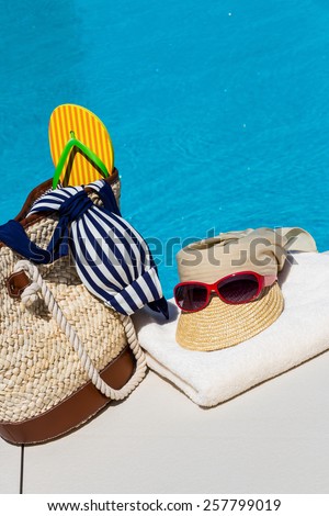 utensils for a nice relaxing vacation day lying next to a swimming pool. relaxation on vacation.