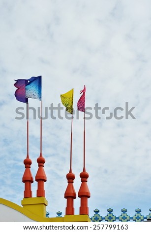  Four bright flags against blue sky