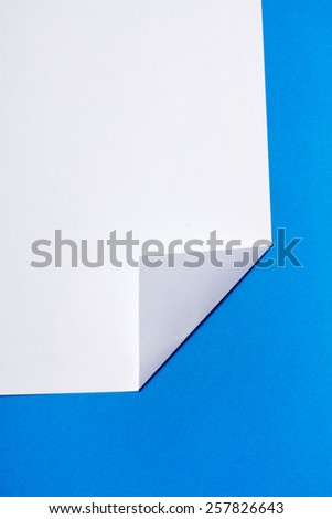 White piece of paper over a blue background.